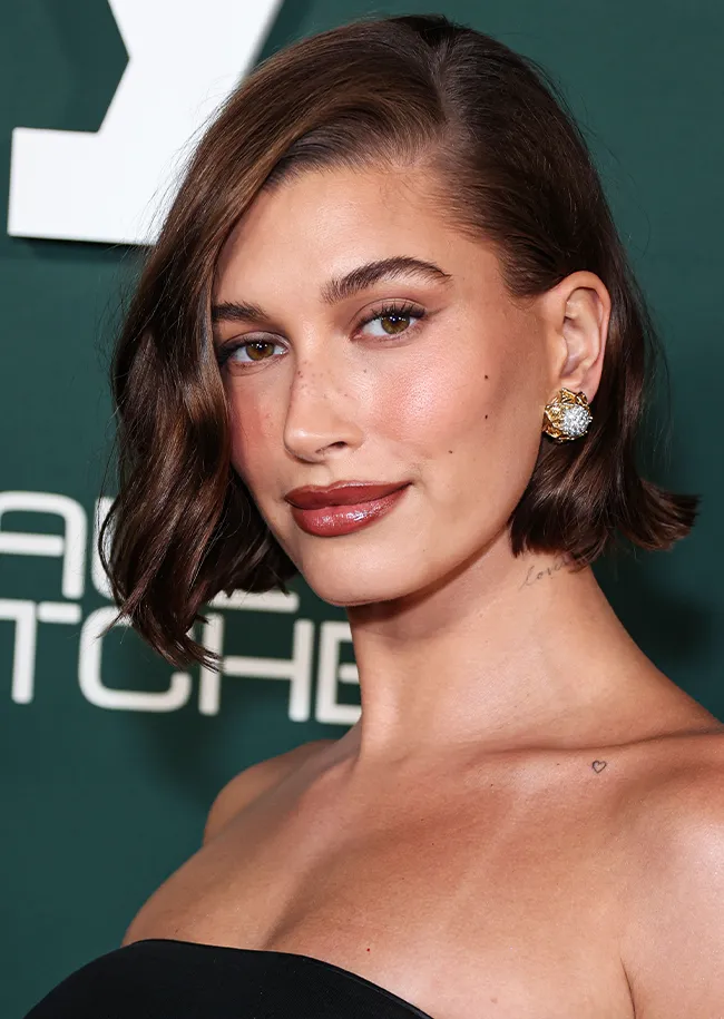 Hailey Bieber attending Baby2Baby event in stylish outfit.