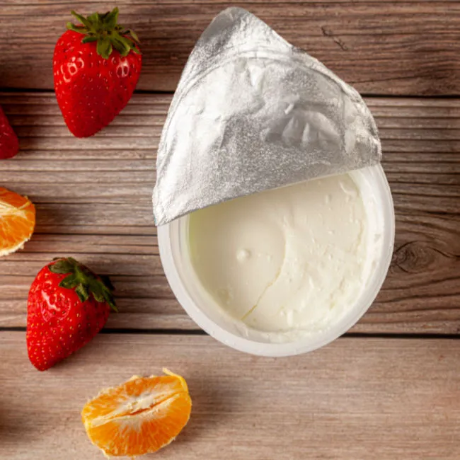 Low-fat yogurt in a bowl with fresh fruits.