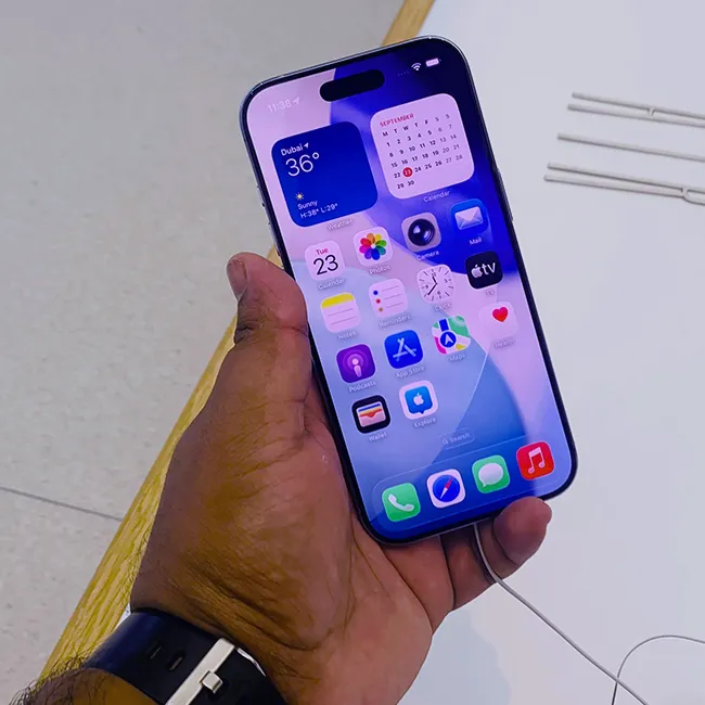 Man holding iPhone 17 Max while discussing celebrity news.