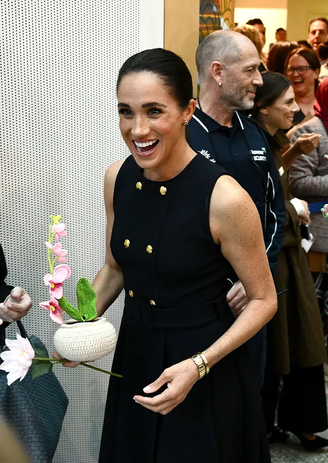 Meghan Markle visiting Royal Children's Hospital in designer attire.