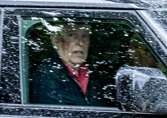 Prince Andrew driving with a noticeable red mark on his cheek.