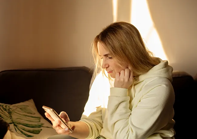 woman-looking-down-phone