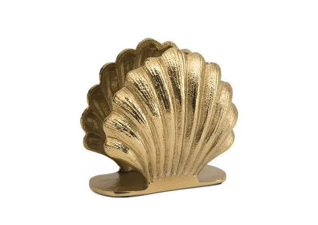 Decorative shell napkin holder for coastal dining decor.