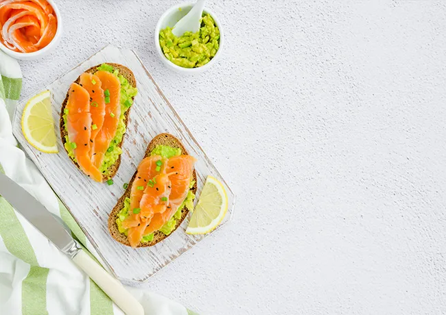 Avocado toast topped with smoked salmon or turkey.