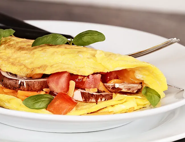 Colorful vegetable omelette served on a plate.