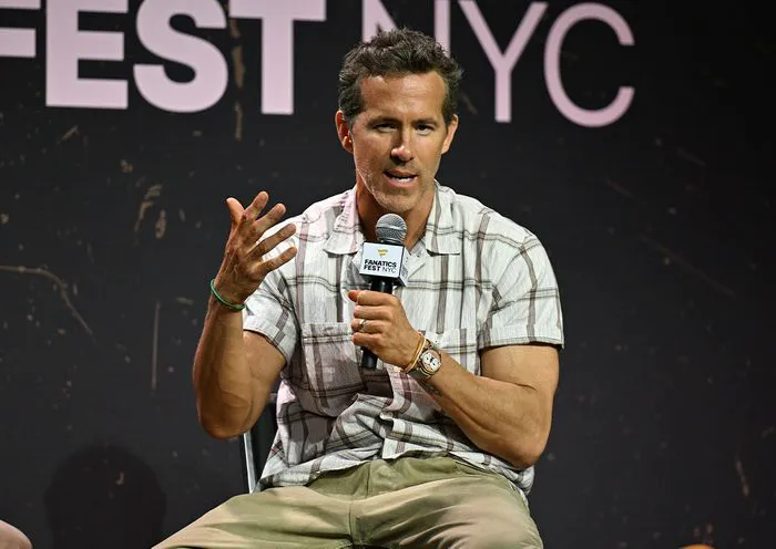 Ryan Reynolds speaking on stage at Fanatics Fest