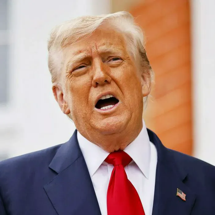 President Donald Trump poses for pictures before a meeting with the British Prime Minister