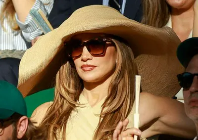 "Jennifer Lopez wearing a large hat at Wimbledon"