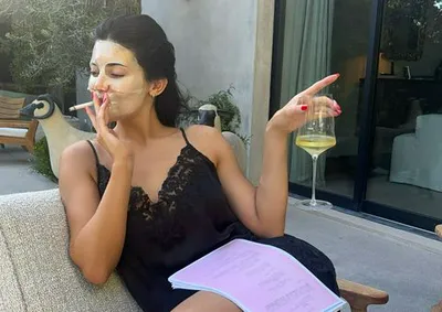 Kylie Jenner black slip dress smoking