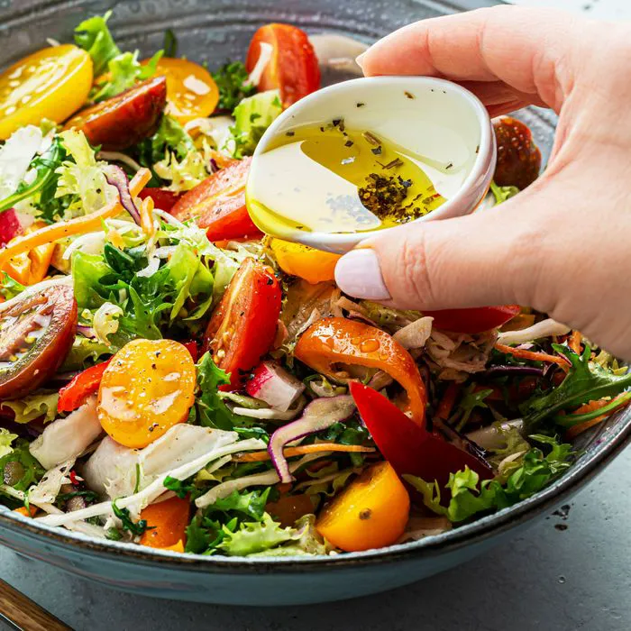 Selection of salad dressings arranged in a row.