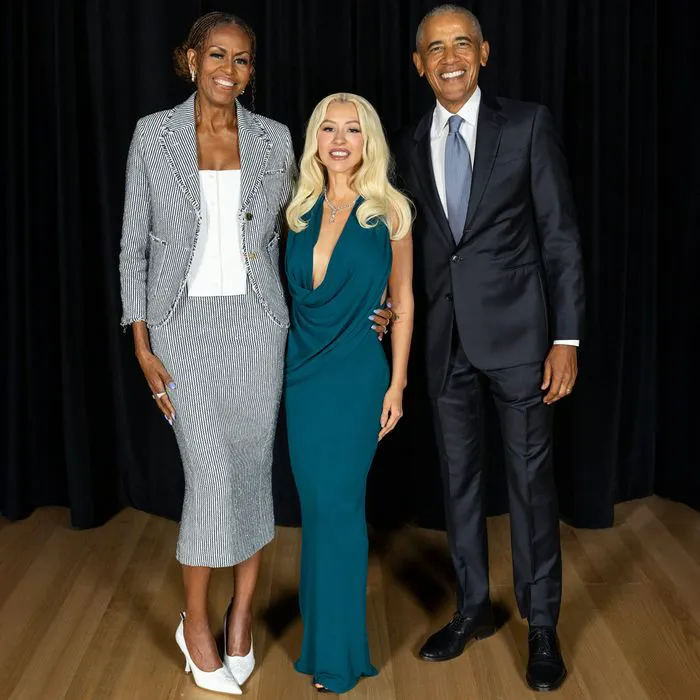 "Christina Aguilera posing with Barack Obama and Michelle Obama"