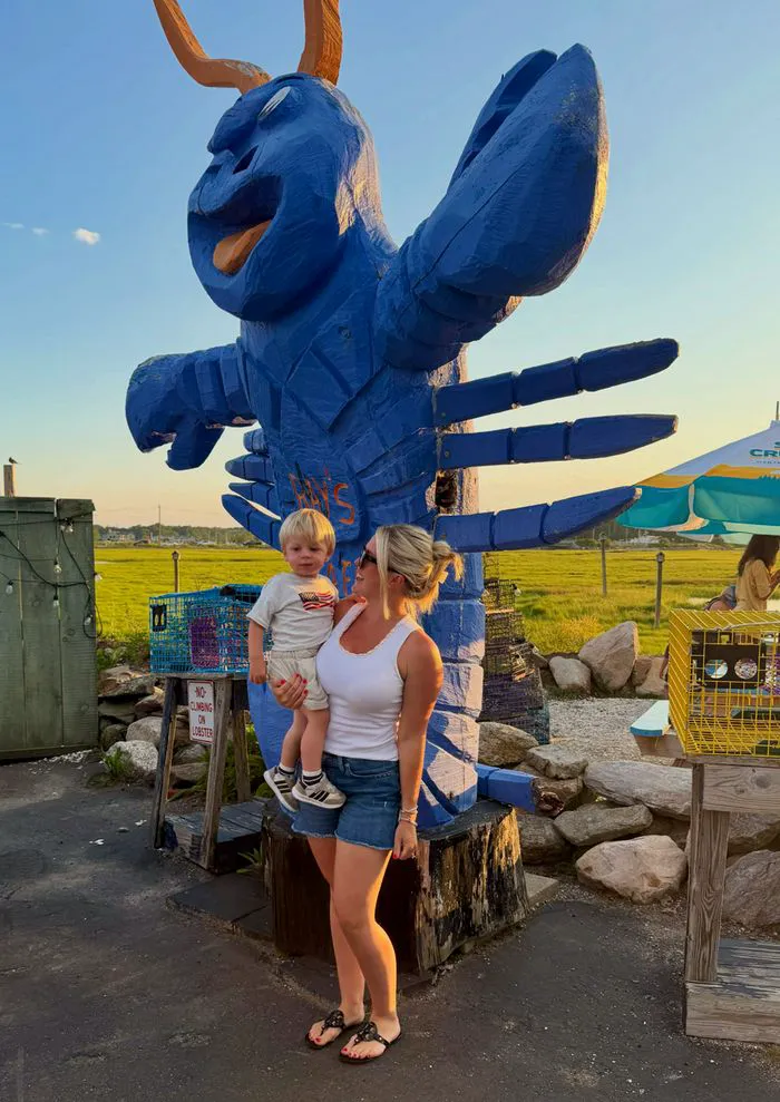 Karoline Leavitt in a white tank top and denim shorts with her son