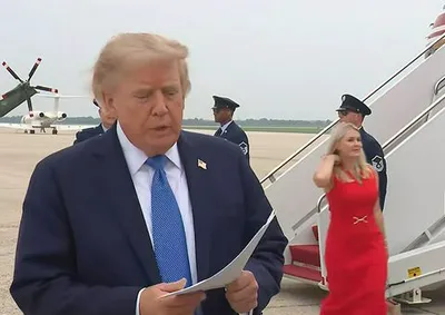 Karoline Leavitt in a red dress with Donald Trump