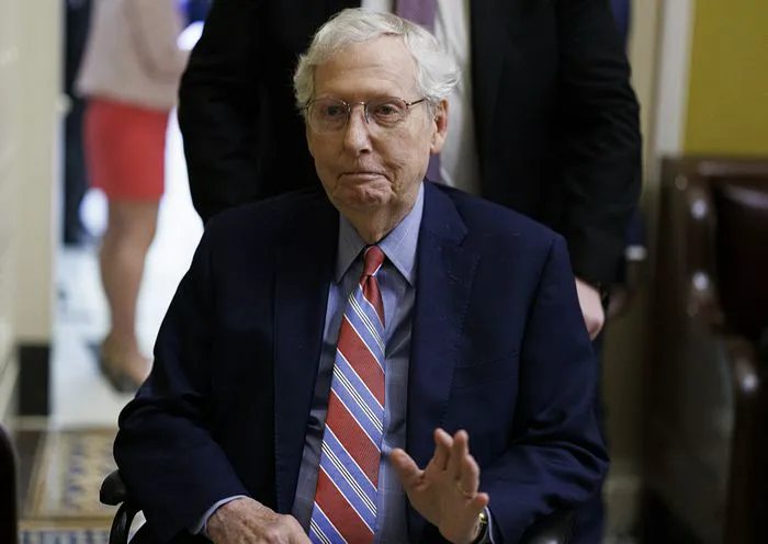 Mitch McConnell departs a meeting