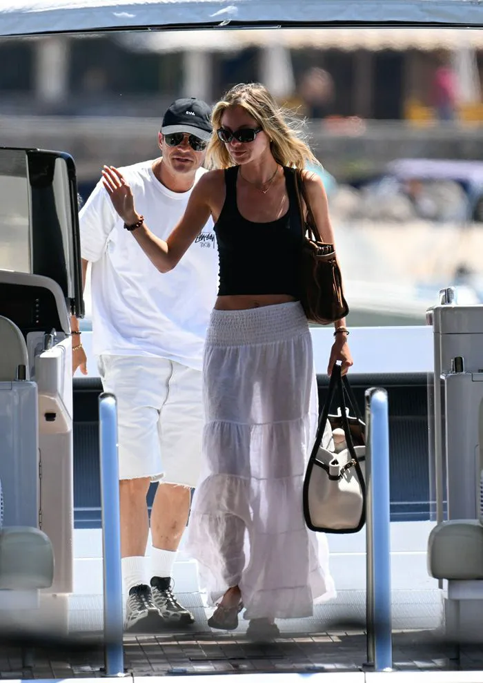 "Orlando Bloom and Luisa Laemmle boarding a boat in Mallorca"