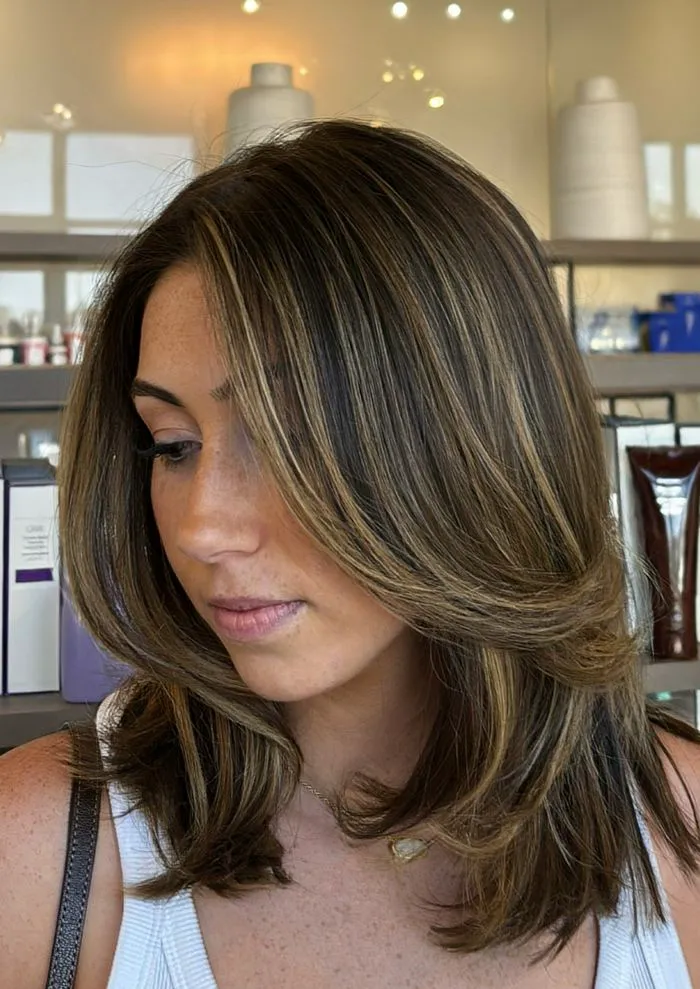 Woman with brown hair in a stylish slip bob haircut.