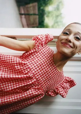 Ariana Grande in a playful babydoll dress at an event.