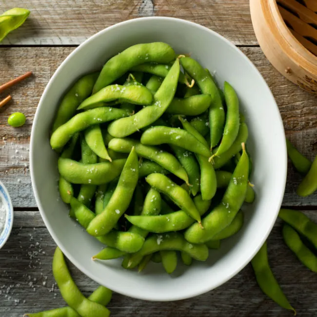 "Fresh edamame pods in a bowl"