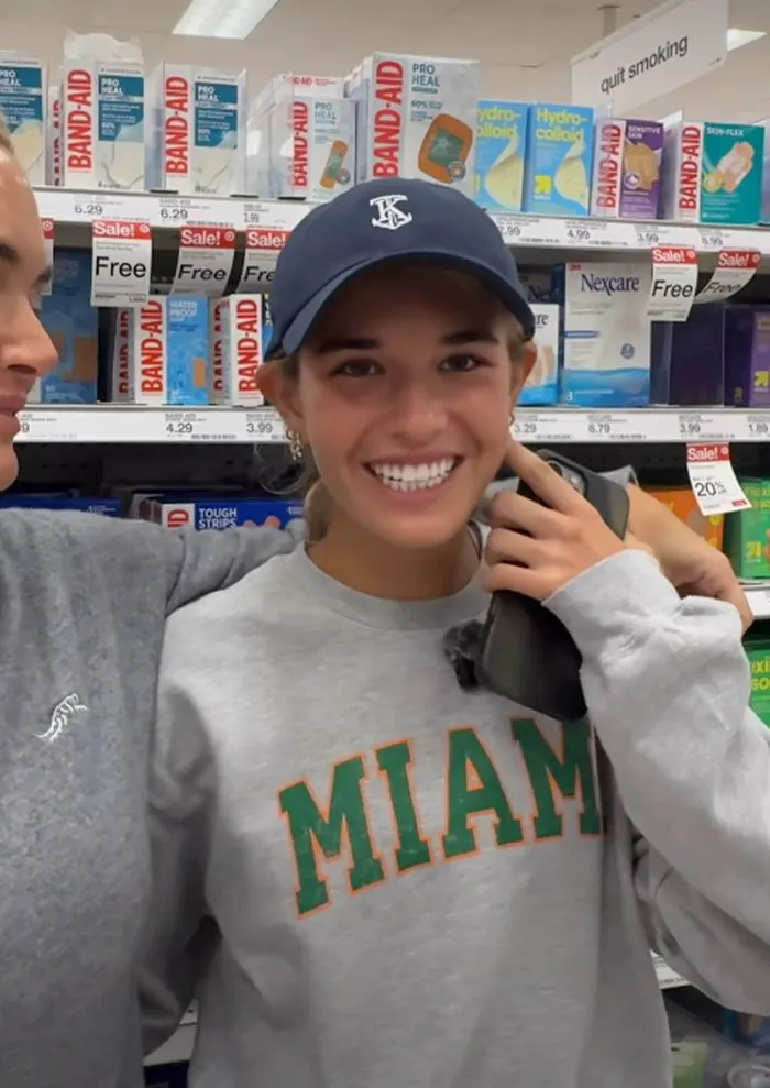Kai Trump in a gray University of Miami sweater