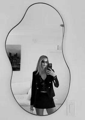 "Kai Trump posing in a black mini skirt and blazer"