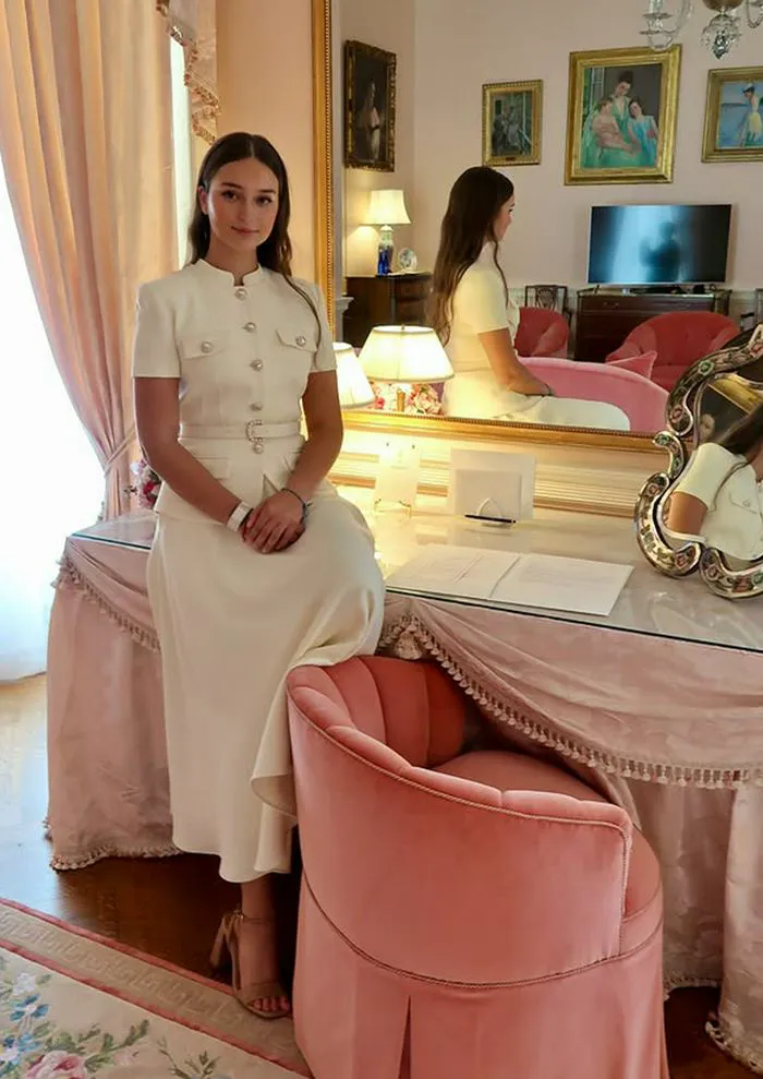 "Arabella Kushner posing in her chic dress"