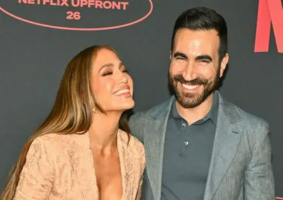 Jennifer Lopez and Brett Goldstein laughing