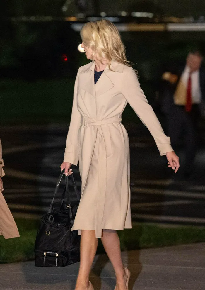 Natalie Harp in a beige wrap coat