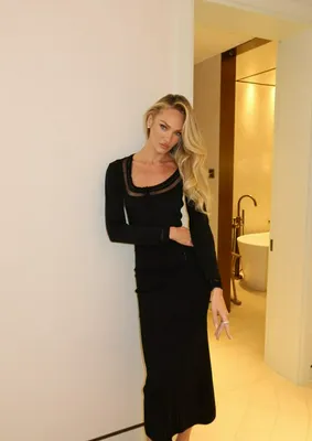 Candice Swanepoel in elegant black dress at event.