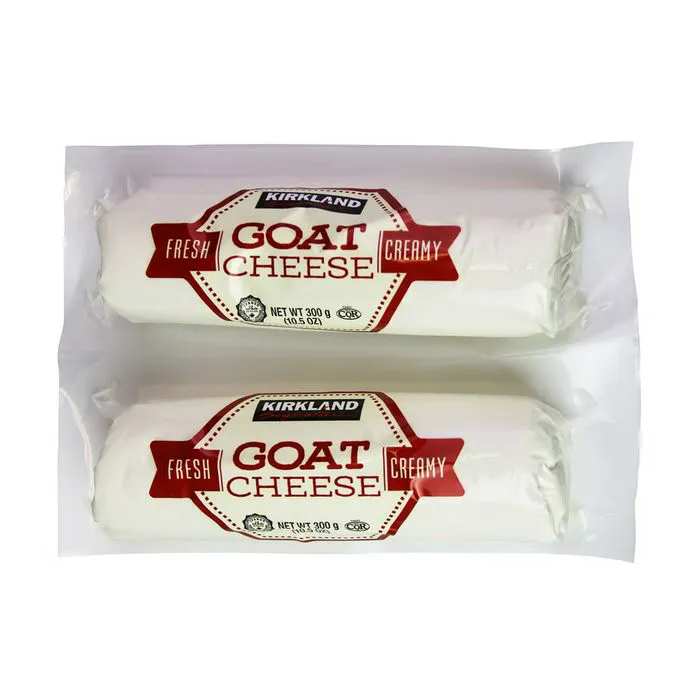 Creamy goat cheese served on a rustic wooden board.