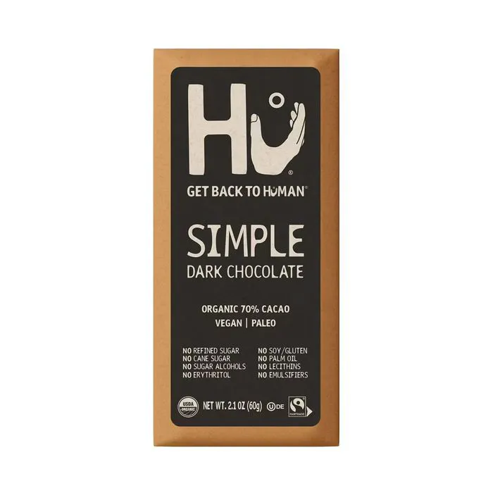 Hu dark chocolate bar displayed on a marble countertop.