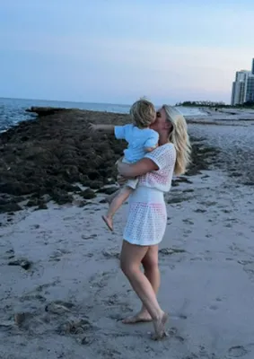 "Karoline Leavitt wearing a crochet cover-up with her son at the beach"