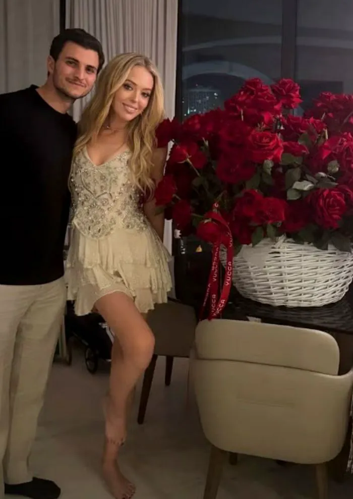 Tiffany Trump and husband surrounded by roses, radiating love.